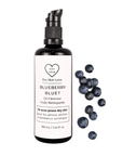 Miron violet glass bottle of blueberry face cleanser displayed with fresh blueberries on a white background, Dry Skin Love Blueberry Oil Cleanser for Acne-Prone Skin.