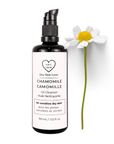 Miron violet glass bottle of chamomile face cleanser displayed with a fresh chamomile flower on a white background, Dry Skin Love Chamomile Oil Cleanser for Sensitive Skin.
