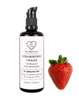 Miron violet glass bottle of strawberry face cleanser displayed with a fresh strawberry on a white background, Dry Skin Love Strawberry Oil Cleanser for Mature Skin.